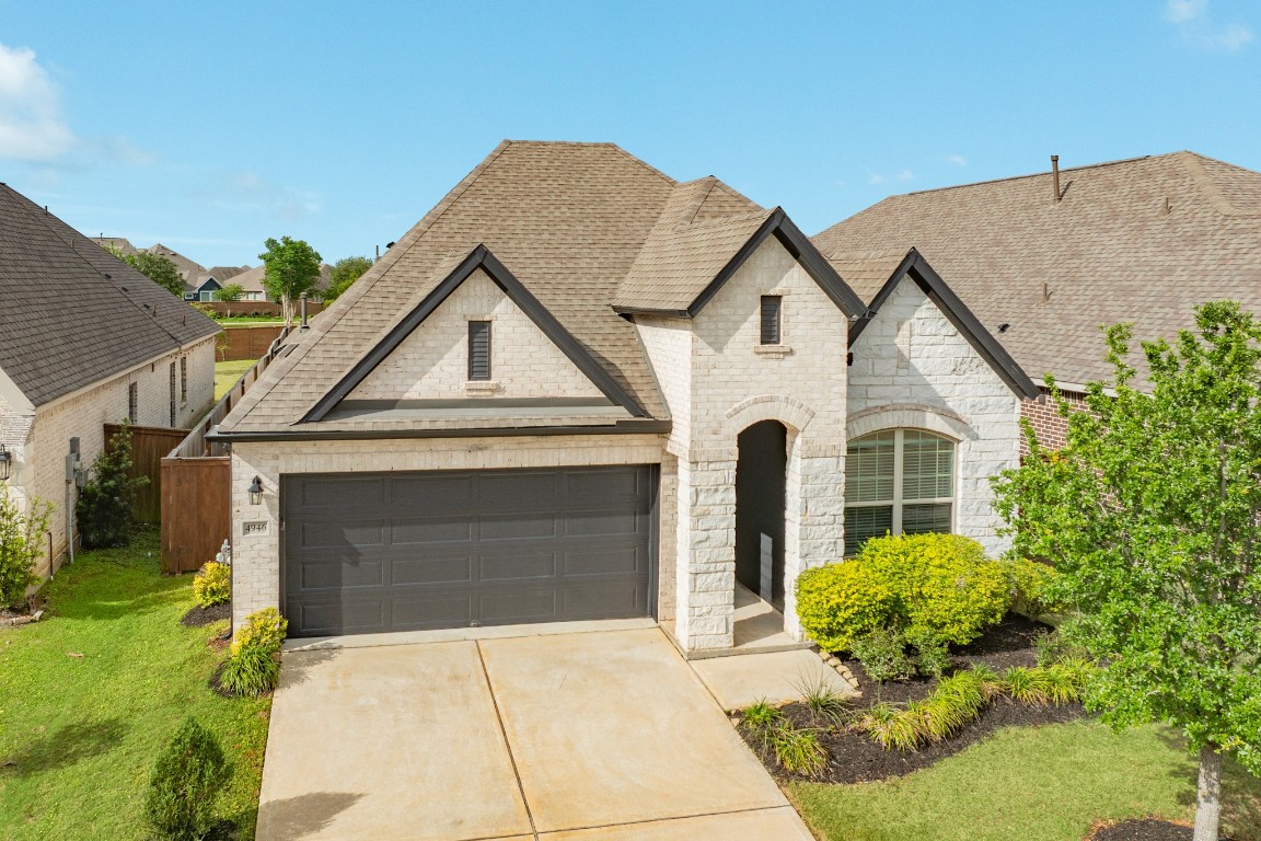 4946 Hitchings Court Rosharon, TX 77583 - Photo 32 of 49 aerial view of the front of the home, highlighting the beautiful brick and stone exterior.