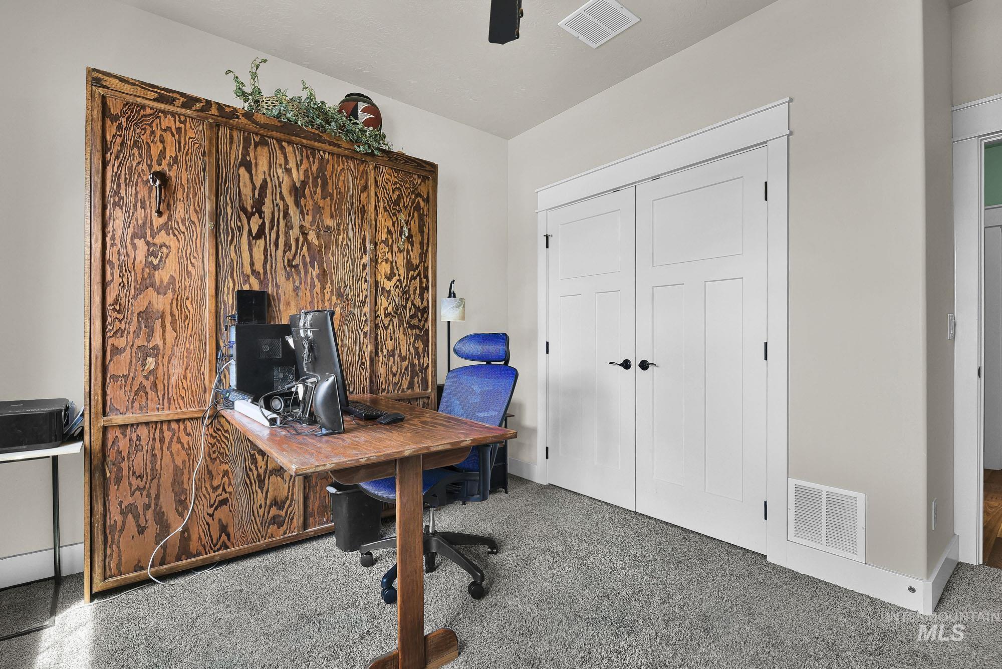 220 South Wildgrass Way Star, ID 83669 - Photo 28 of 50 Reach-in closet featuring white built-in shelving, two chrome hanging rods, and a gray carpeted floor