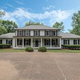 a front view of a house with a yard and porch