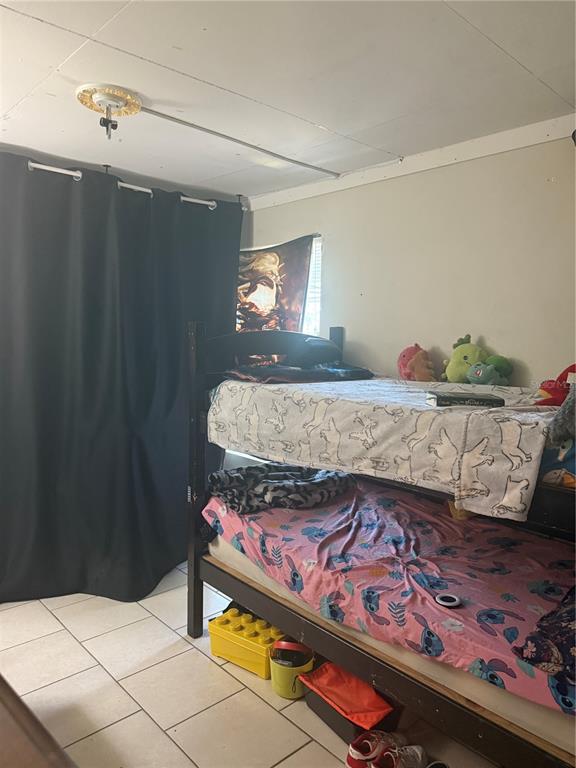 528 Briarwood Road Venice, FL 34293 - Photo 11 of 44 a bedroom with a bed and a dresser