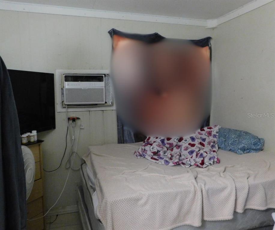 528 Briarwood Road Venice, FL 34293 - Photo 13 of 44 a bedroom with a bed and a flat screen tv