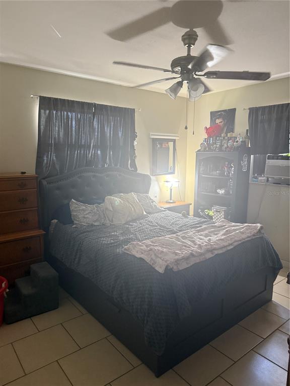 528 Briarwood Road Venice, FL 34293 - Photo 4 of 44 a bedroom with a bed and a chandelier