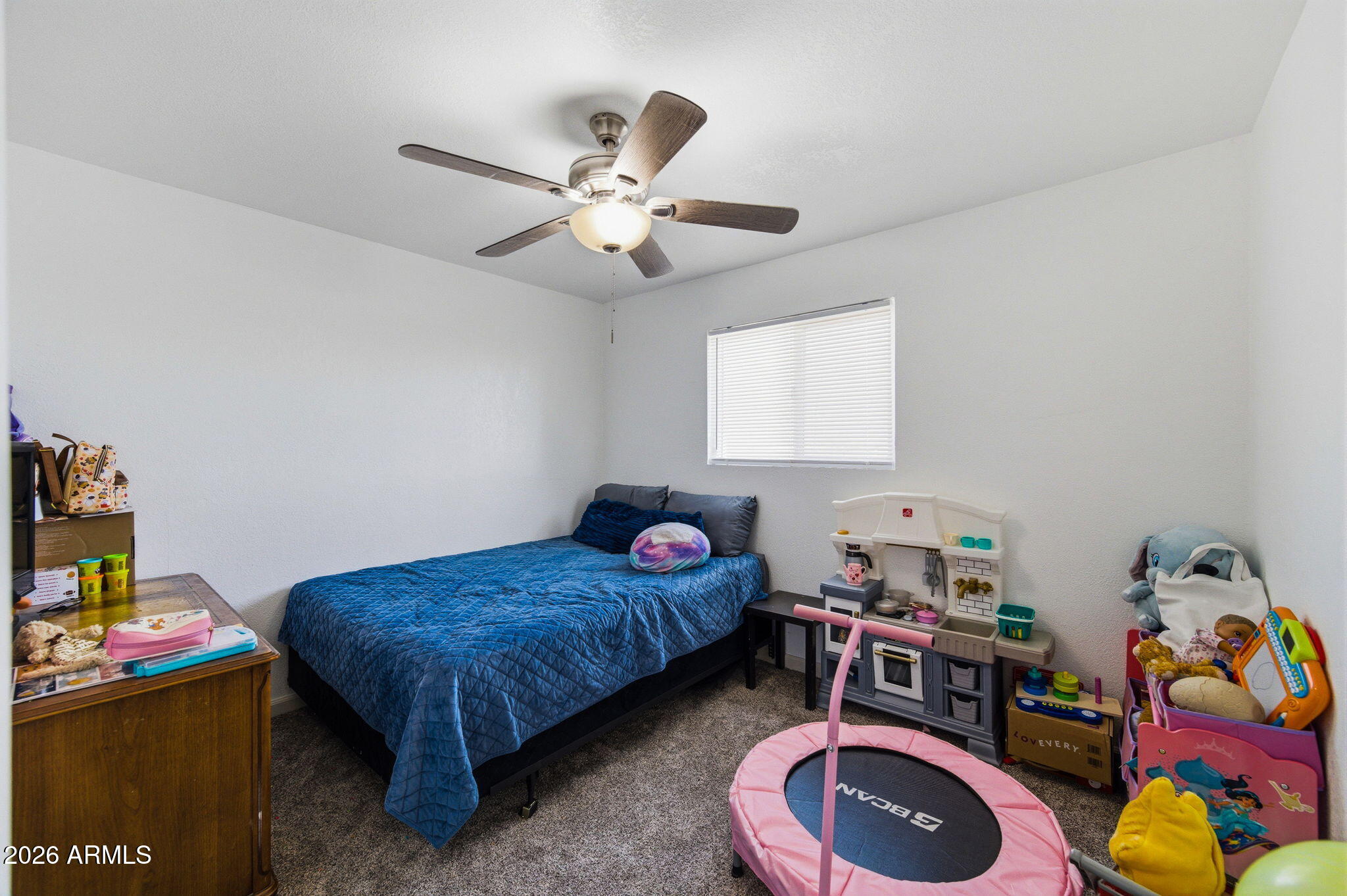 1268 East Rodeo Road Casa Grande, AZ 85122 - Photo 14 of 27 a bedroom with a bed and a chandelier