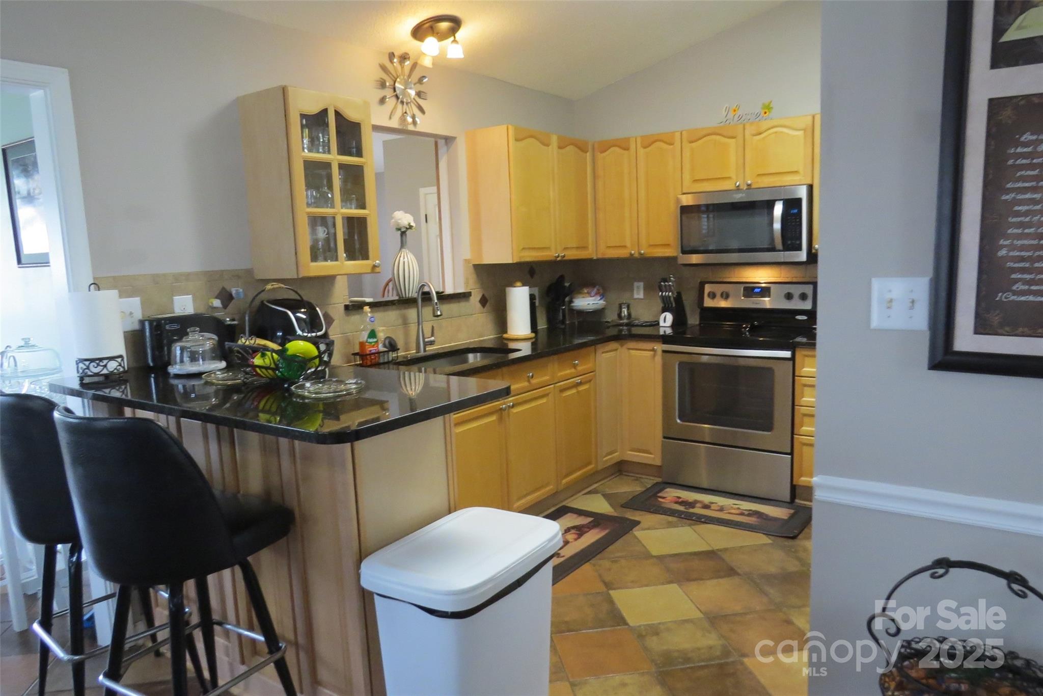 2901 Compton Court Northwest Concord, NC 28027 - Photo 12 of 35 a kitchen with a sink stove and microwave