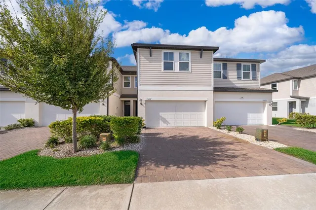 a front view of a house with a garden and plants