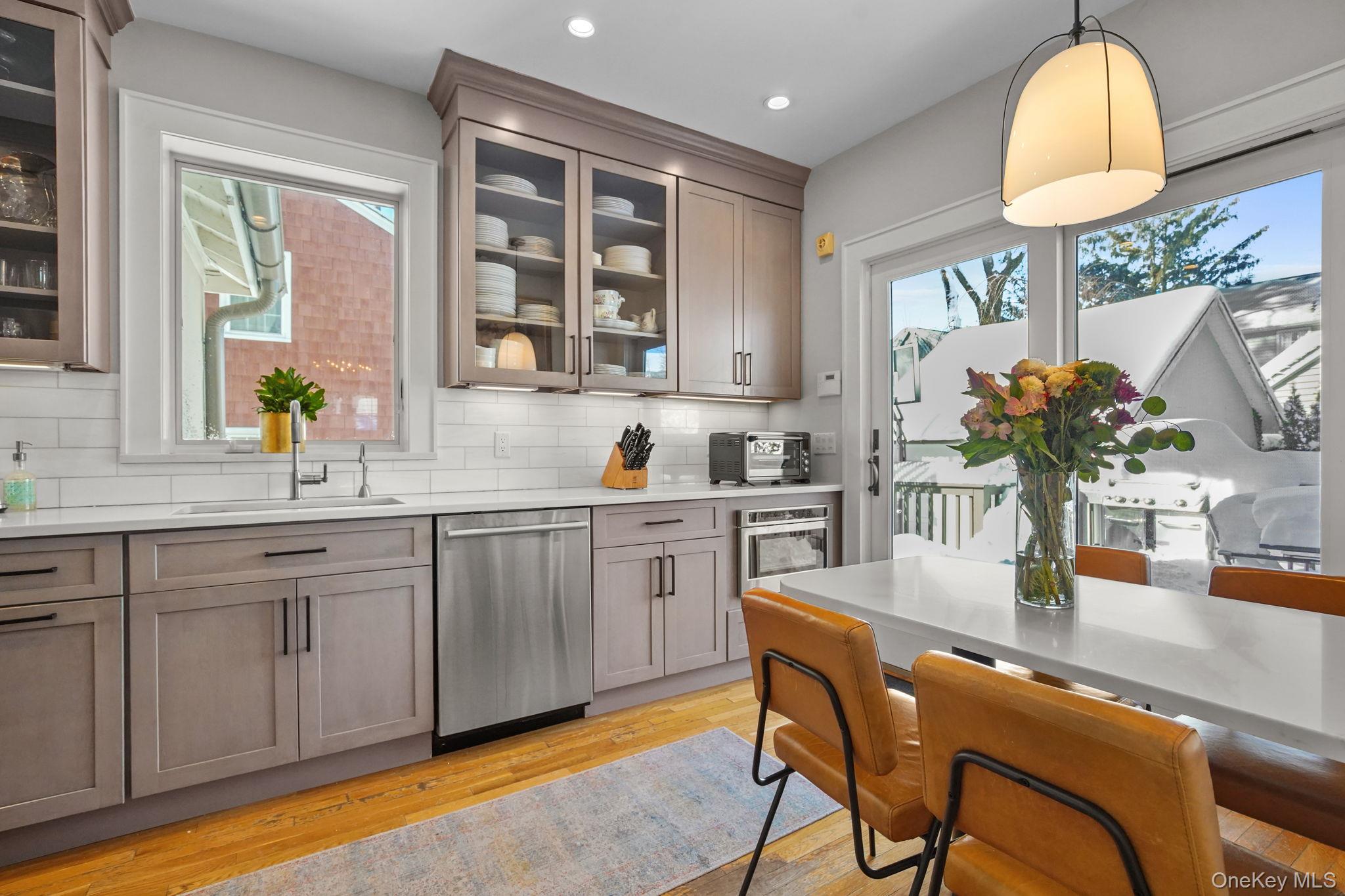 181 Webster Road Scarsdale, NY 10583 - Photo 11 of 30 a kitchen with a table chairs sink and cabinets