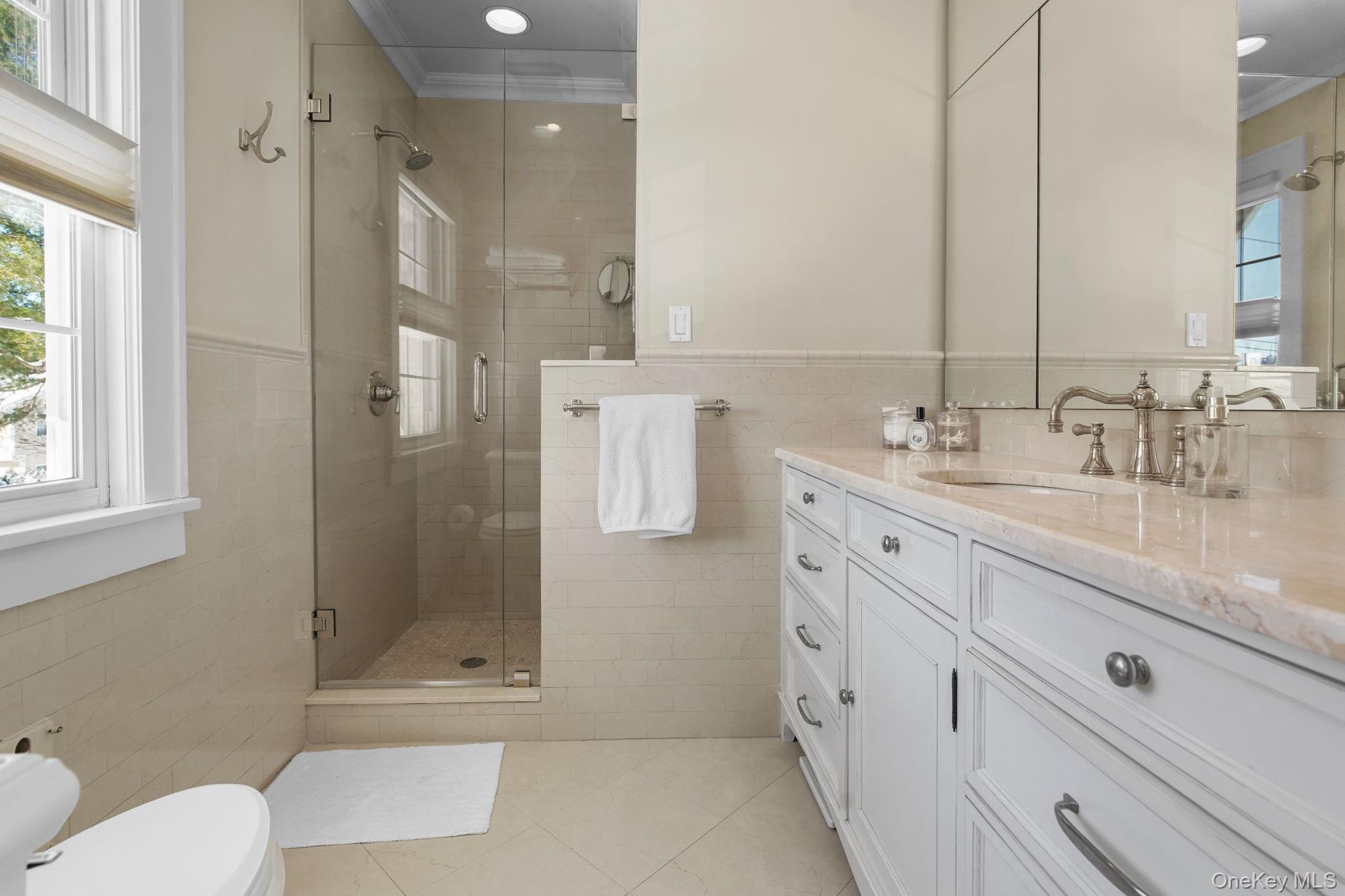 181 Webster Road Scarsdale, NY 10583 - Photo 20 of 30 a bathroom with a granite countertop sink mirror and double