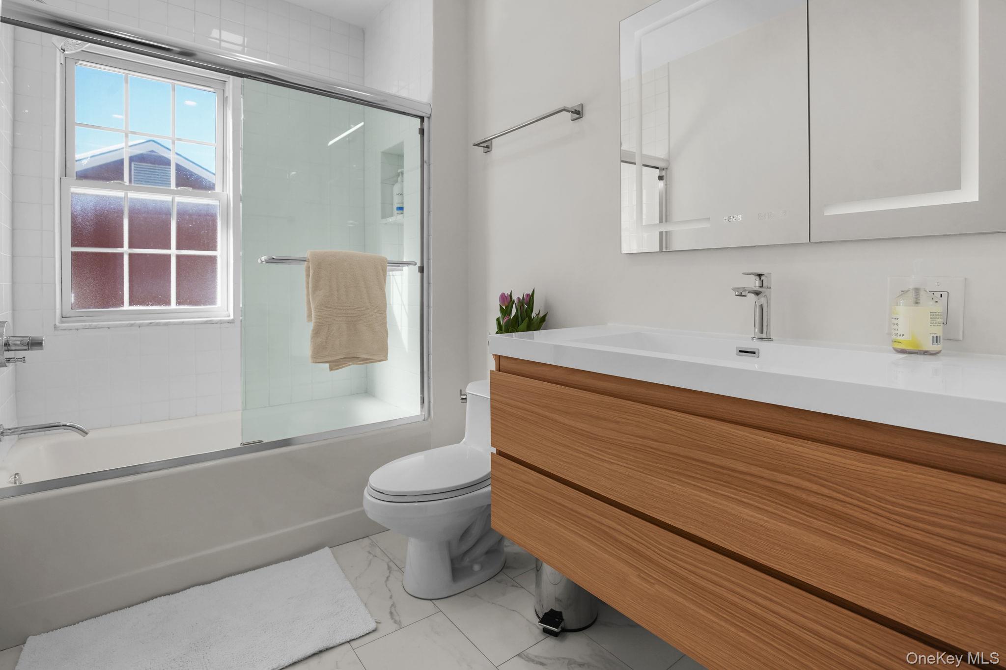 181 Webster Road Scarsdale, NY 10583 - Photo 22 of 30 a bathroom with a sink toilet and shower