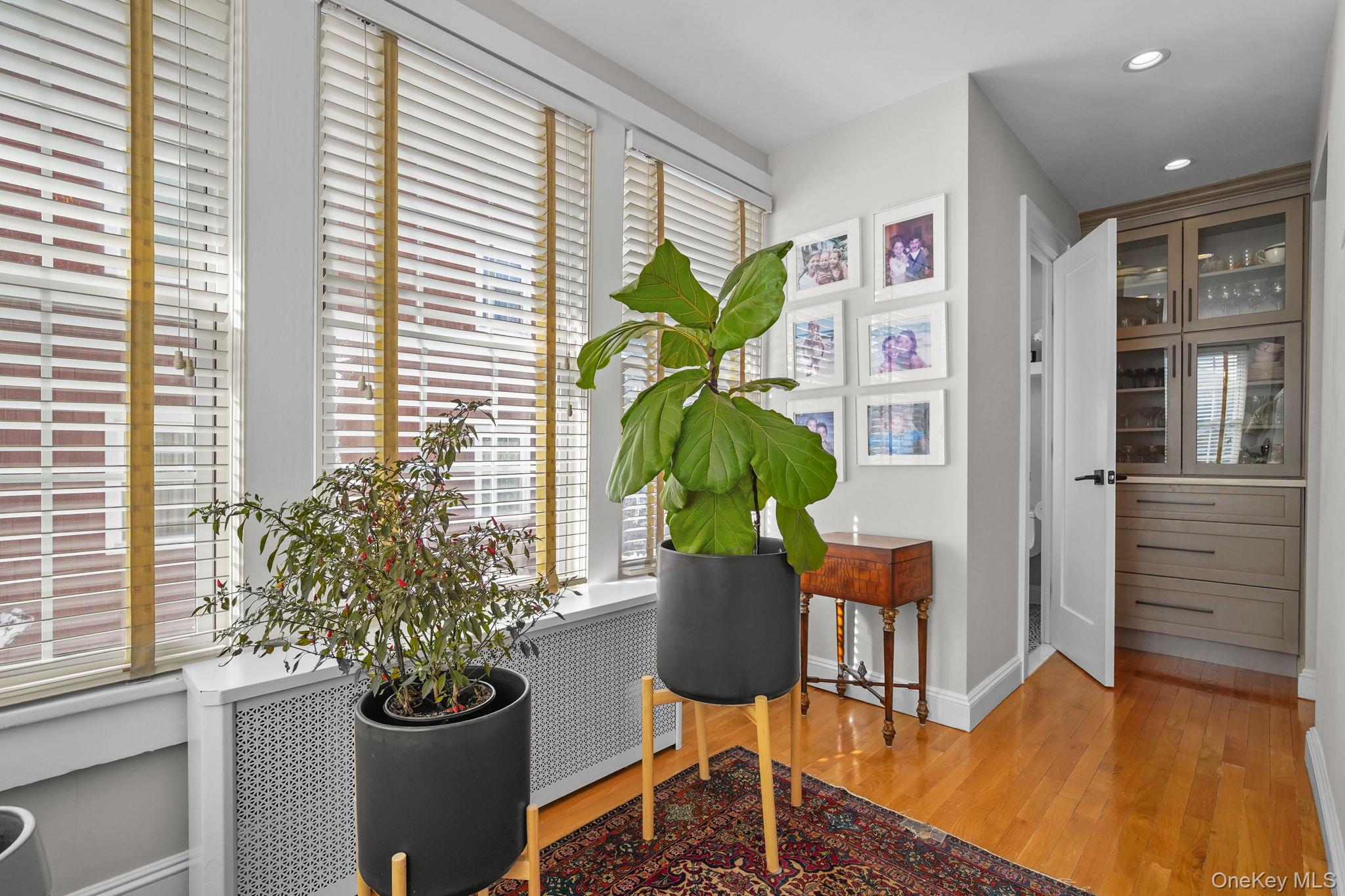 181 Webster Road Scarsdale, NY 10583 - Photo 7 of 30 a vase of flowers sitting on a table in front of a window