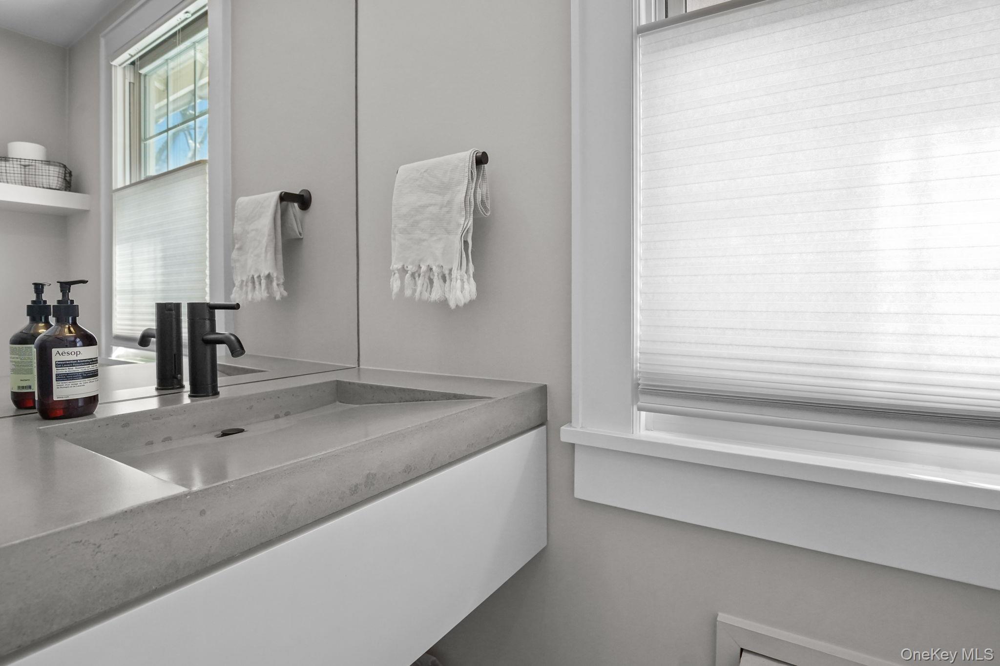 181 Webster Road Scarsdale, NY 10583 - Photo 8 of 30 a bathroom with a granite countertop sink and a mirror