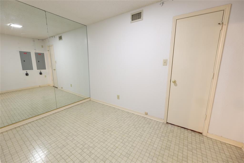 907 Red Oak Creek Road Ovilla, TX 75154 - Photo 12 of 20 Room featuring a full wall mirror, white painted walls, and light-toned tile flooring