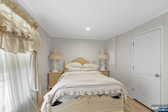 a bed sitting in a bedroom next to a window