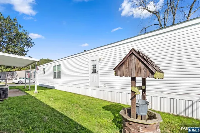 a front view of house with a garden and patio