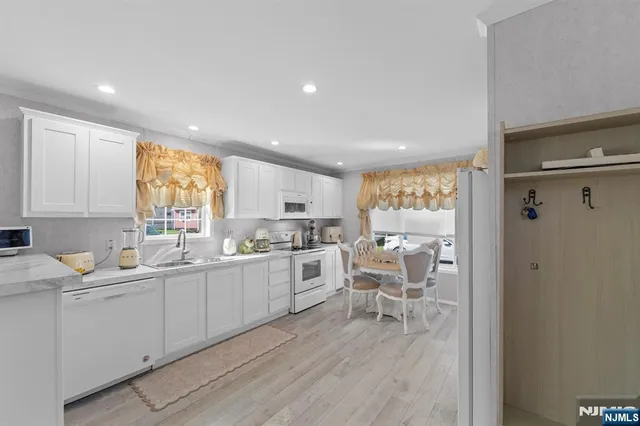 a kitchen with a sink stove and wooden cabinets