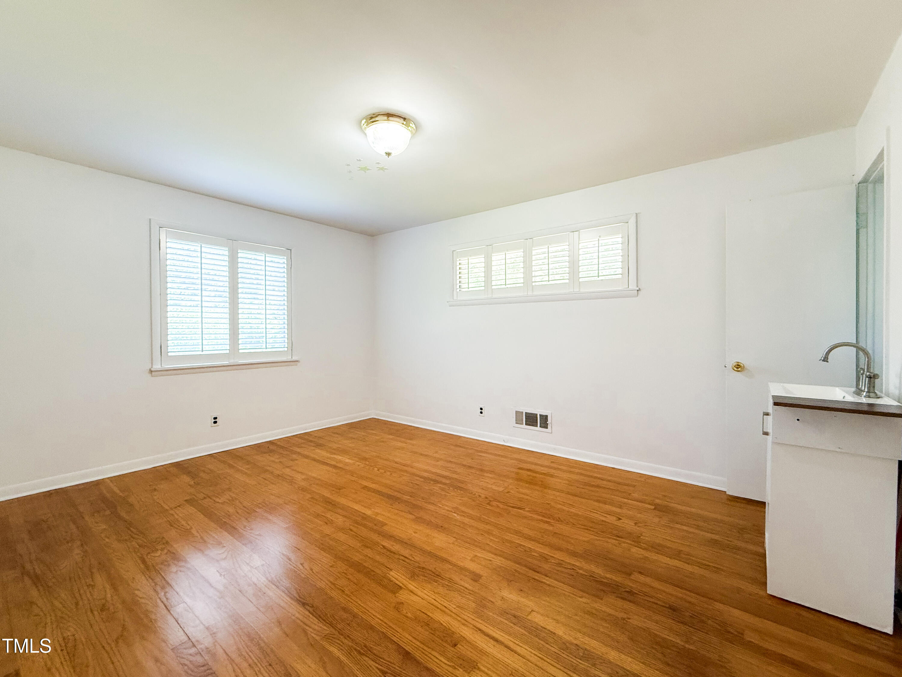 3323 Baugh Street Raleigh, NC 27604 - Photo 25 of 52 a view of empty room with wooden floor and fan