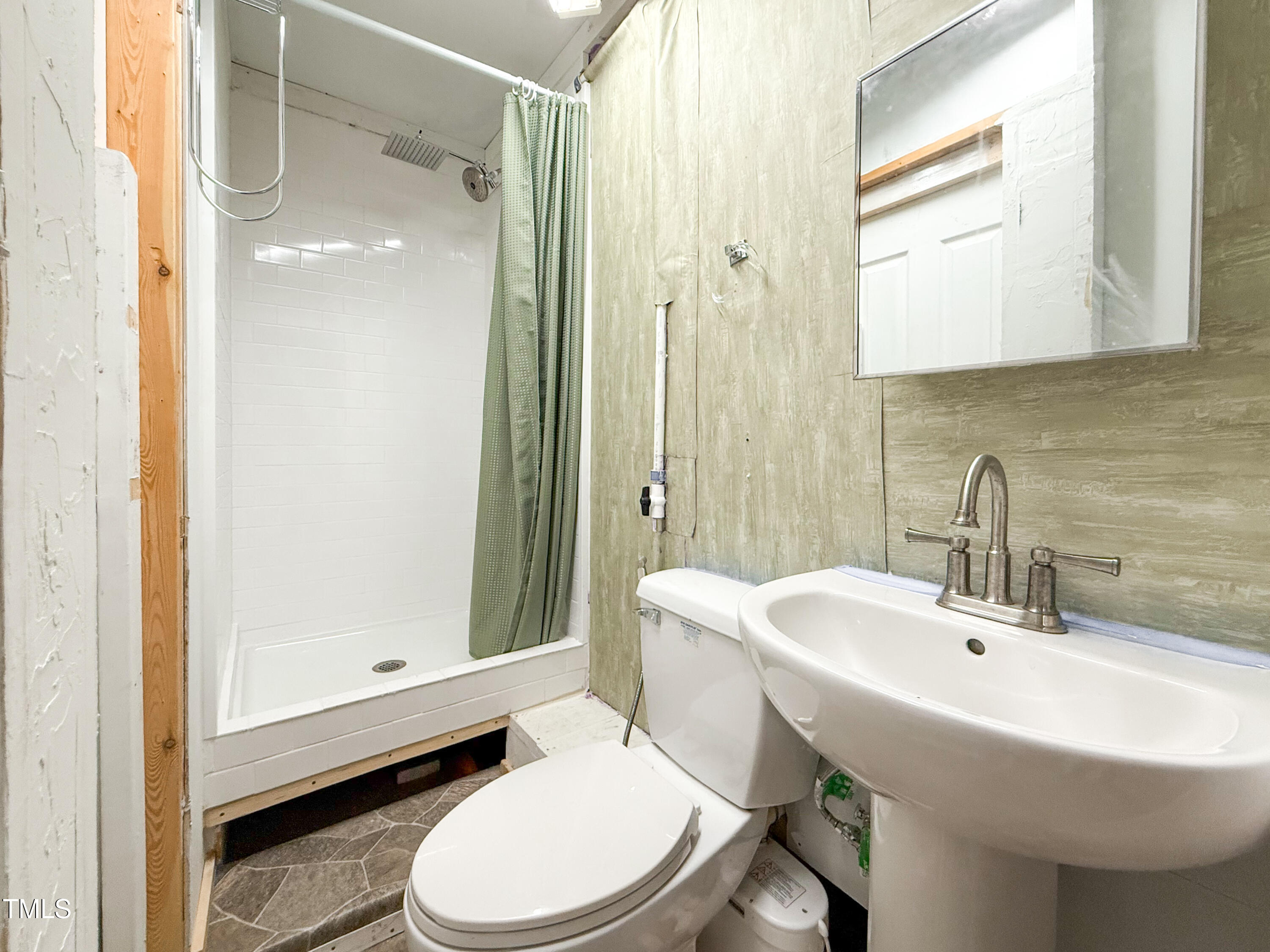 3323 Baugh Street Raleigh, NC 27604 - Photo 35 of 52 a bathroom with a sink a toilet and shower