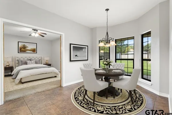 a living room with furniture chandelier and a large window