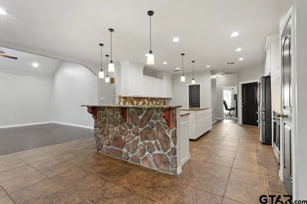 a view of a kitchen with a sink stainless steel appliances and cabinets