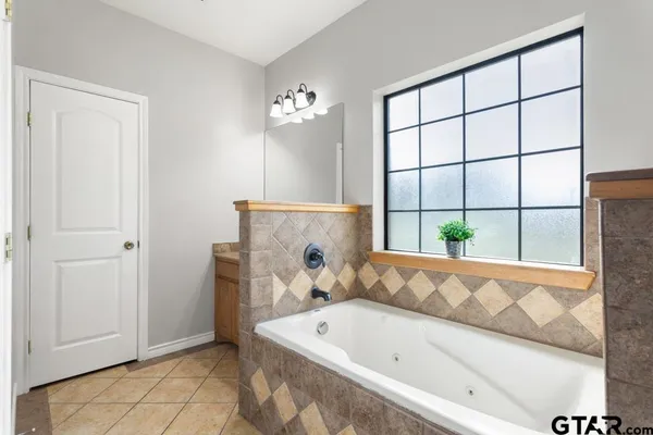 a bathroom with a tub and a shower