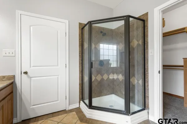 a bathroom that has a glass shower door