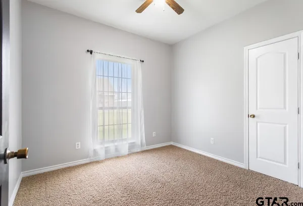 an empty room with windows and entrance
