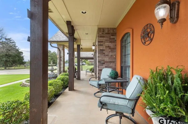 a balcony with table and chairs