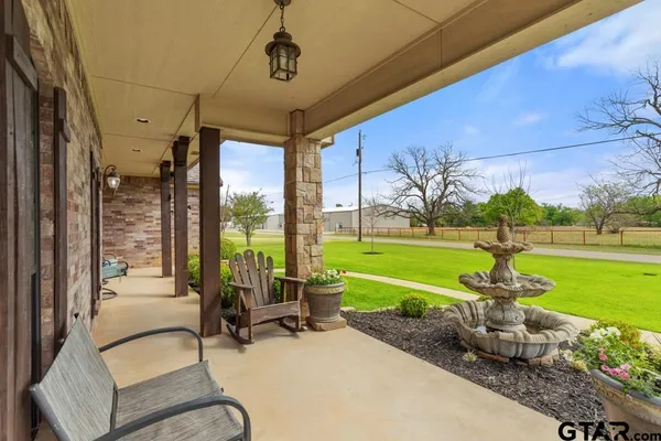 a view of a patio with a table chairs and a swimming pool