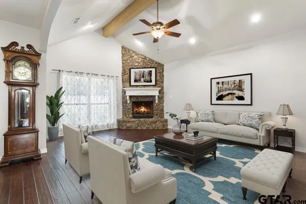 a living room with furniture and a fireplace