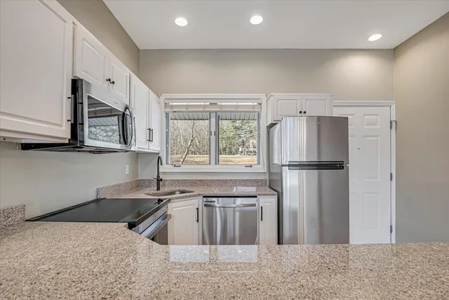 a bedroom with a large bed and a couch