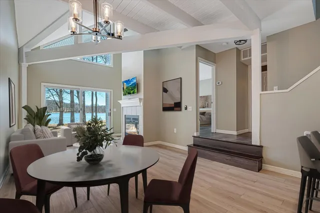 a view of a livingroom with wooden floor and a fireplace