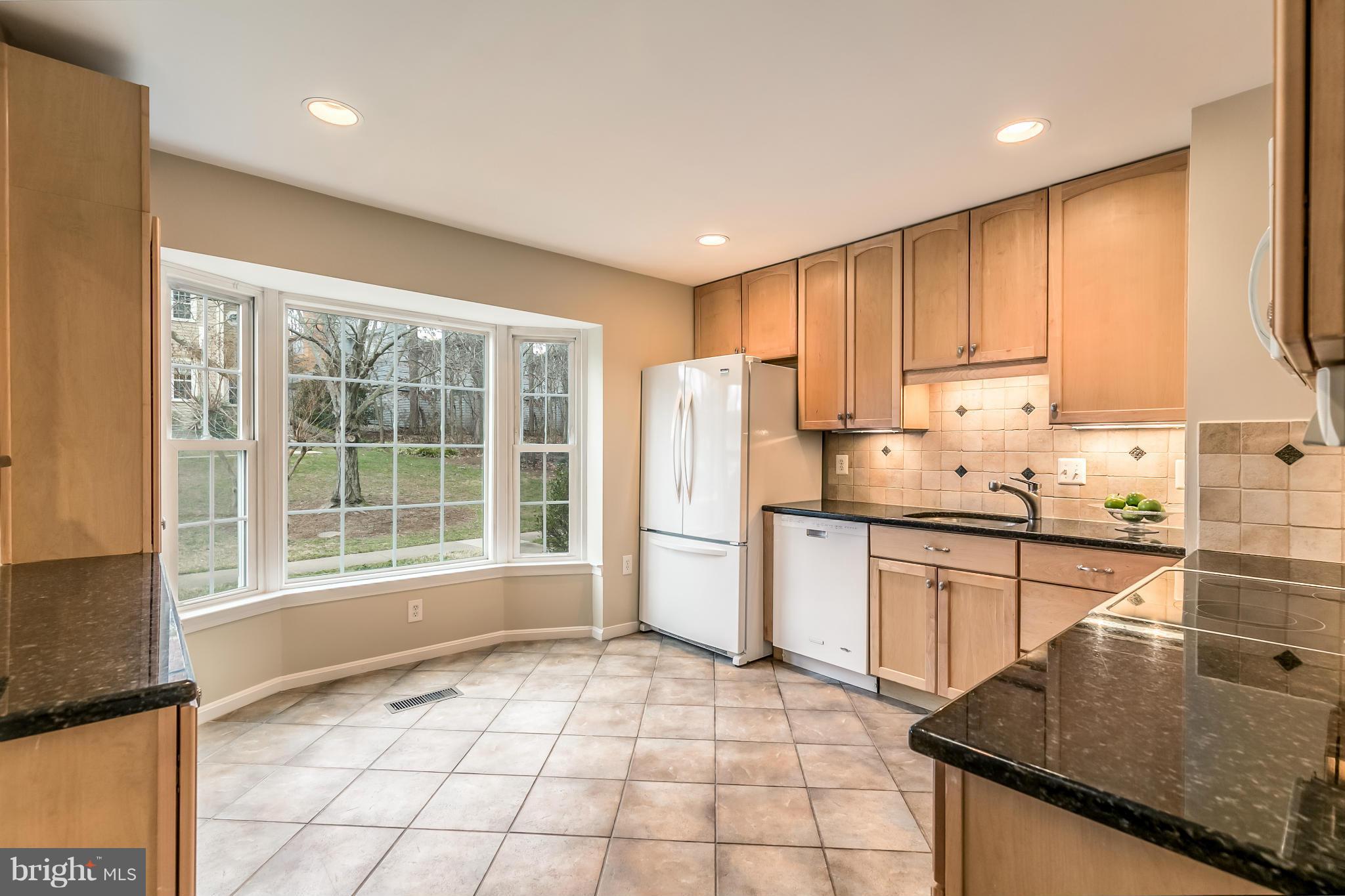 11974 Sentinel Point Court Reston, VA 20191 - Photo 2 of 26 a kitchen with granite countertop a stove a sink and a refrigerator
