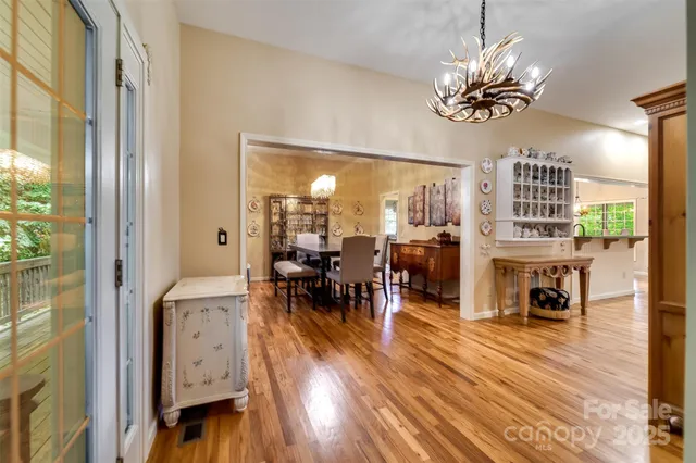 a view of a livingroom with furniture wooden floor and a chandelier