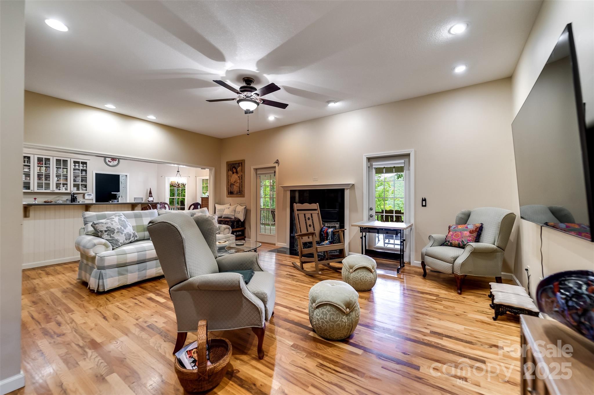 1838 Coman Road Franklin, NC 28734 - Photo 16 of 48 a living room with furniture a fireplace and a flat screen tv