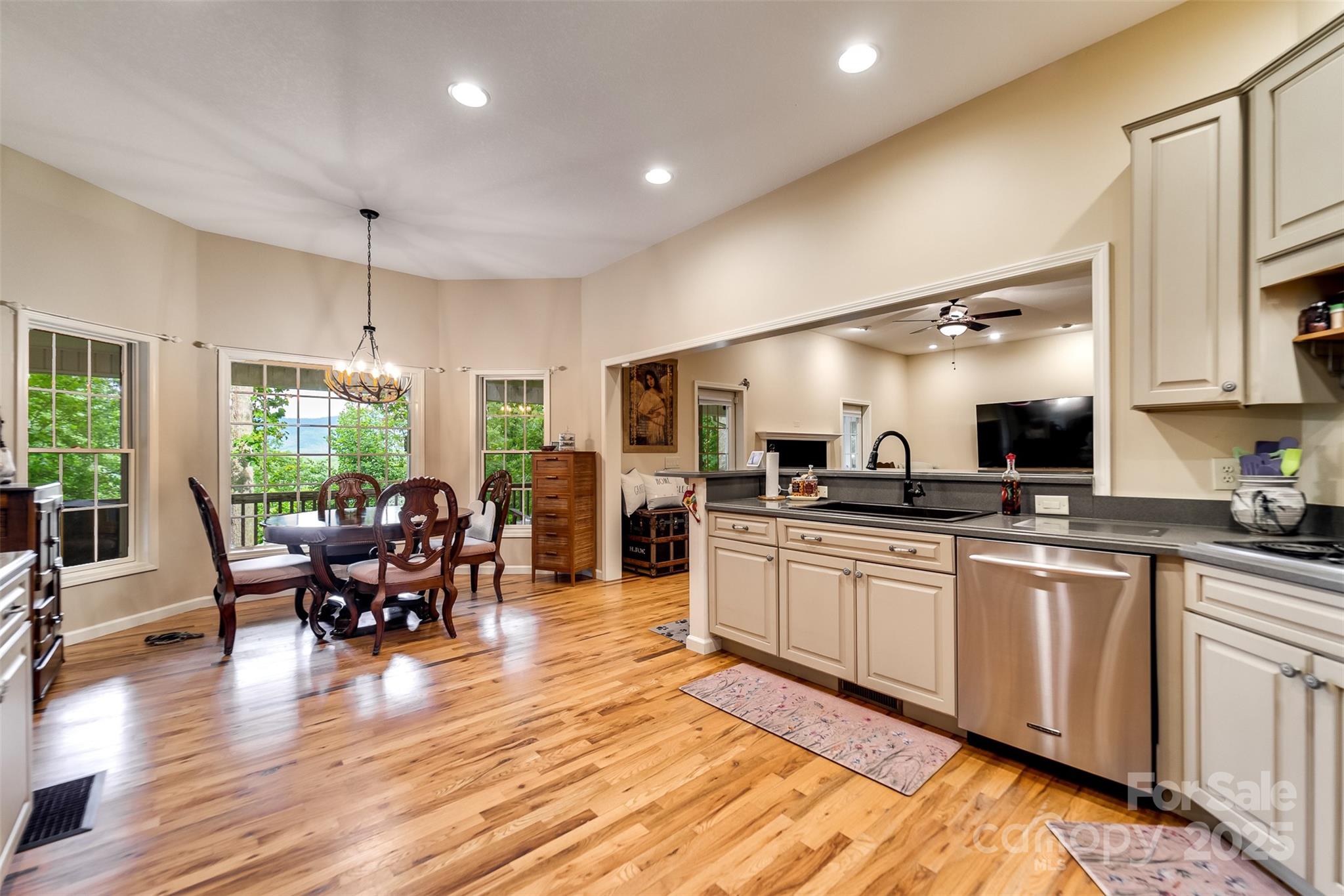 1838 Coman Road Franklin, NC 28734 - Photo 22 of 48 a kitchen with stainless steel appliances granite countertop sink stove and wooden cabinets