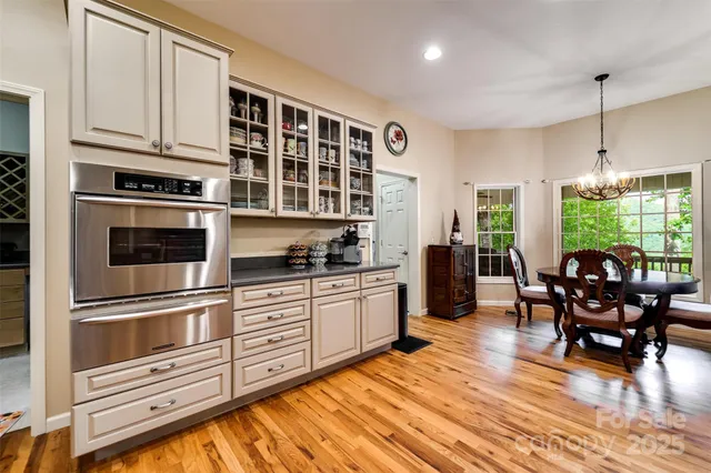 a kitchen with stainless steel appliances granite countertop a stove and white cabinets