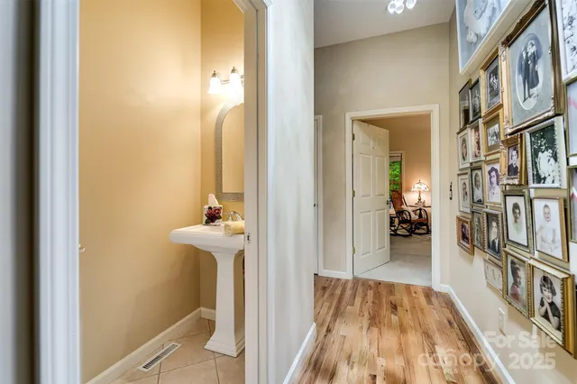 a view of a hallway with furniture and floor to ceiling window