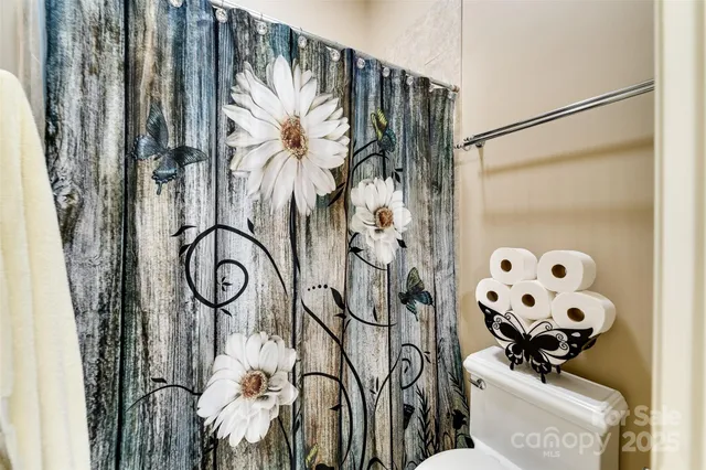a picture of a bathroom with a shower and a curtain