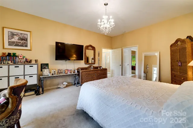 a large bedroom with furniture and flat screen tv