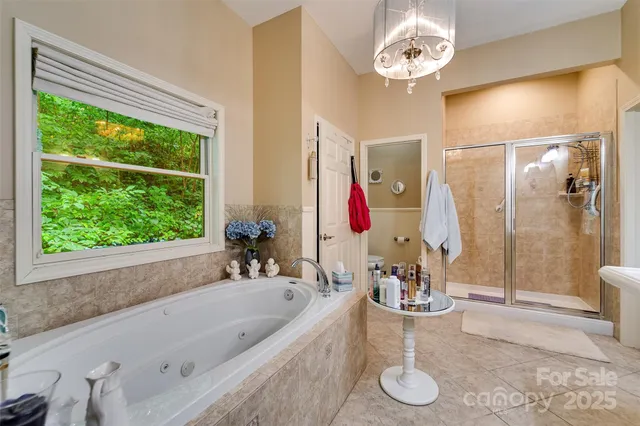 a bathroom with a tub sink and mirror