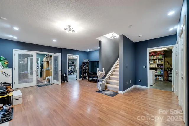a view of a hall with stairs and a couch