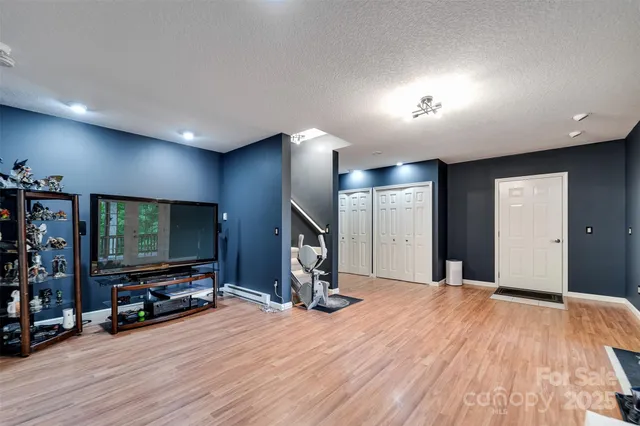 a view of a livingroom with wooden floor and furniture