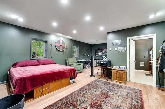 a bed room with a bed and mirror