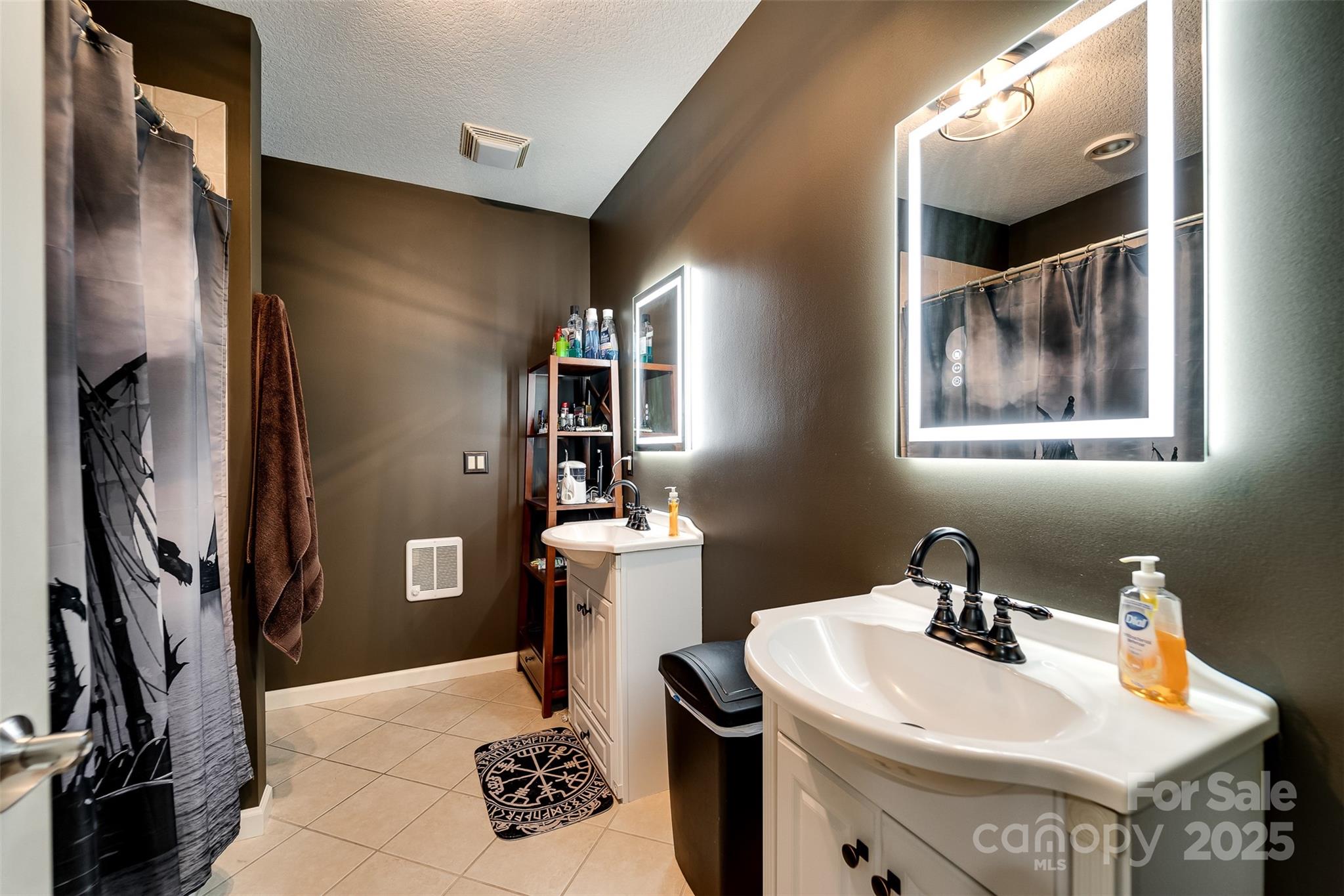 1838 Coman Road Franklin, NC 28734 - Photo 41 of 48 a bathroom with a sink toilet and mirror
