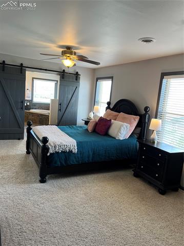 7675 Walker Road Colorado Springs, CO 80908 - Photo 3 of 3 Owner's suite has barn doors to the adjoining 5PC bathroom.