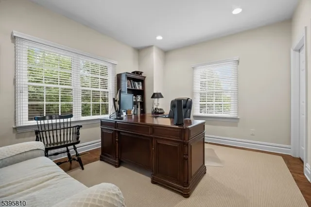 a view of a workspace with furniture and a window