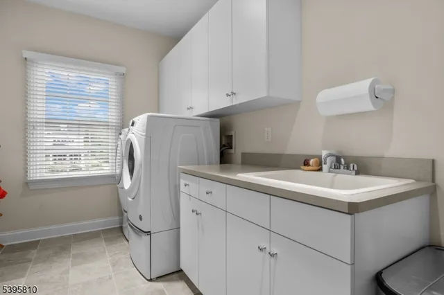 a bathroom with a sink a toilet and a window