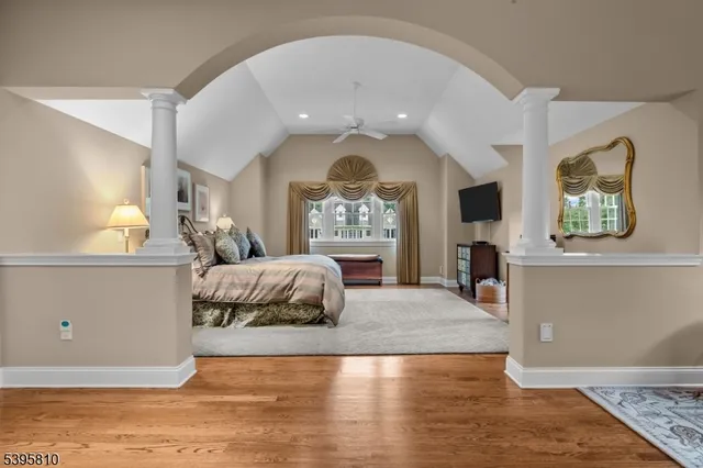 a spacious bedroom with a bed and a large window