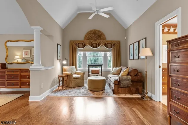 a living room with fireplace furniture and a wooden floor