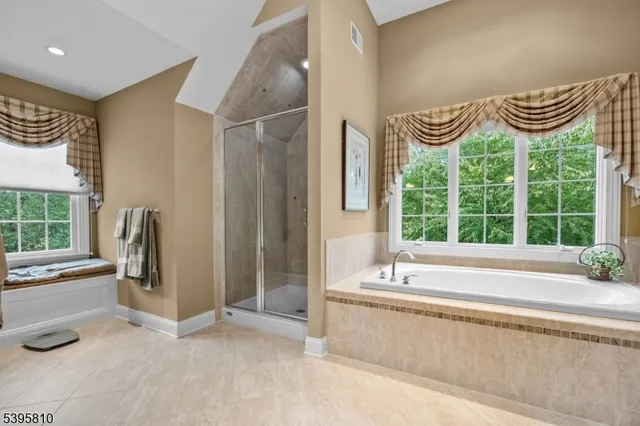 a spacious bathroom with a bathtub and a large window