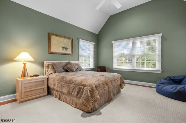 a spacious bedroom with a bed and a lamp